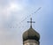 Flock of swans over the dome and the cross of an Orthodox church in the autumn sky