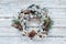 Flocked Christmas Wreath over White Wooden Table Background