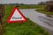 Flood. A flood warning road sign beside a flooded road