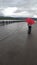 Flood. Flooded embankment. Girl with a red umbrella. Krasnoyarsk, Yenisei