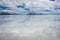 Flooded Bonneville Salt Flats in Utah create a mirror reflection scene on the water, looking surreal