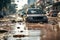 Flooded cars on on city street. Dirt and destruction after natural flood disaster