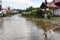 Flooded city street after thunderstorm. The road and the sidewalk are covered with water after the massive rain. The flood makes