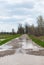 Flooded country lane with large puddles