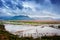 The flooded fields and crops with dramatic clouds