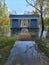 Flooded Huron River at old Greek Revival shelter at Island Park in Ann Arbor, Michigan