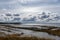 Flooded lake shore, overgrown with last year`s reeds and bushes, bird migration, beautiful cumulus clouds