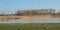 Flooded marsh with bare trees and reed in bourgoyen nature reserve in Ghent