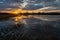 Flooded meadow after downpour, clouds and sunset