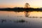 Flooded meadow at sunset with reflections in the water