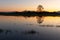 Flooded meadow at sunset with reflections in the water