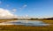 Flooded nature reserve with wind turbines in the background