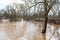 Flooded pedestrian bridge and trees in spring day, Ranki, Latvia