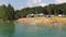 The flooded quarry is a resting place and a beach. Beach entertainment. Beach on a flooded quarry. An artificial beach in a floode