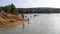 The flooded quarry is a resting place and a beach. Beach entertainment. Beach on a flooded quarry. An artificial beach in a floode