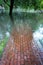 Flooded red brick walkway, reiny cloudy day