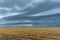 Flooded rice fields under dark stormy clouds with antenna