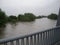 Flooded river in central Europe from a bridge.Floods and storms are very common due to climate change. Water, flood.