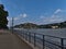 Flooded riverside promenade in city Koblenz with Rhine river on high water level with metal railing fortress Ehrenbreitenstein.