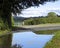 Flooded road, peaceful setting.