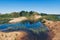 Flooded sand quarry near Sychevo. Lush green summer landscape for outdoors vacation, hiking, camping or tourism. Volokolamsk