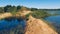 Flooded sand quarry near Sychevo. Lush green summer landscape for outdoors vacation, hiking, camping or tourism. Volokolamsk