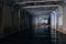 Flooded sewer tunnel is reflecting in water. Dirty urban sewage flowing throw rectangular sewer tunnel