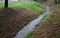 Flooded stream led to a narrow riverbed where the water drains quickly, the bends must be laid out with a stone so that water eros