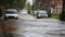 Flooded Street in English Countryside Cars Driving on Water