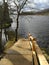 Flooded tourist trail with wooden stairs. River of Daugava rised because of warm weather in winter.