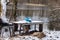 Flooding in early spring. Garbage in a bag in the woods. Flooded table with benches near the pond