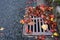 Flooding threat, fall leaves clogging a storm drain on a wet day, street and curb