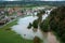 Flooding, water across river plains, farmland, and village, aerial view