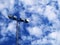 Floodlights from below and blue sky with clouds