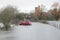 Floods engulf red car