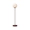 Floor lamp with metal post, glass orb, globe, sphere shade. Electric light, tall interior standing luminaire decoration