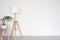 floor lamp and stool with indoor flower on the background of a white empty wall. space for text.