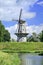 Floor mill build on a city wall with a blue sky and dramatic clouds, Netherlands