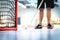 Floorball goal and net. Player training in the background. Man playing floor hockey.