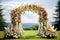 a floral archway set up for an outdoor wedding ceremony