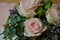 Floral arrangement and decoration. Three bright roses with moss and green leaves close-up. floral design
