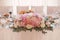 Floral arrangement of pink hydrangea, roses and eustom on the Banquet festive table of the bride and groom