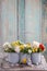 Floral arrangement with springtime flowers: roses, poppies and chamelaucium wax flower