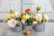 Floral arrangement with springtime flowers: roses, poppies and chamelaucium wax flower