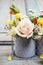 Floral arrangement with springtime flowers: roses, poppies and chamelaucium wax flower