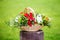 Floral arrangement with strawberries in a basket on the grass.