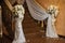 Floral arrangements of roses, white orchids and soft tulle adorn marble steps