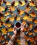 Floral autumn background. A mug of coffee in a woman`s hands on the green background with yellow maple leaves and cones