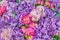 Floral background. Decorative wall made of Artificial blooming peonies of pink and purple colors