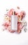 Floral Beauty Product Setup with Butterfly. Cosmetic care bottle and flowers. Beauty Product Presentation or Advertising